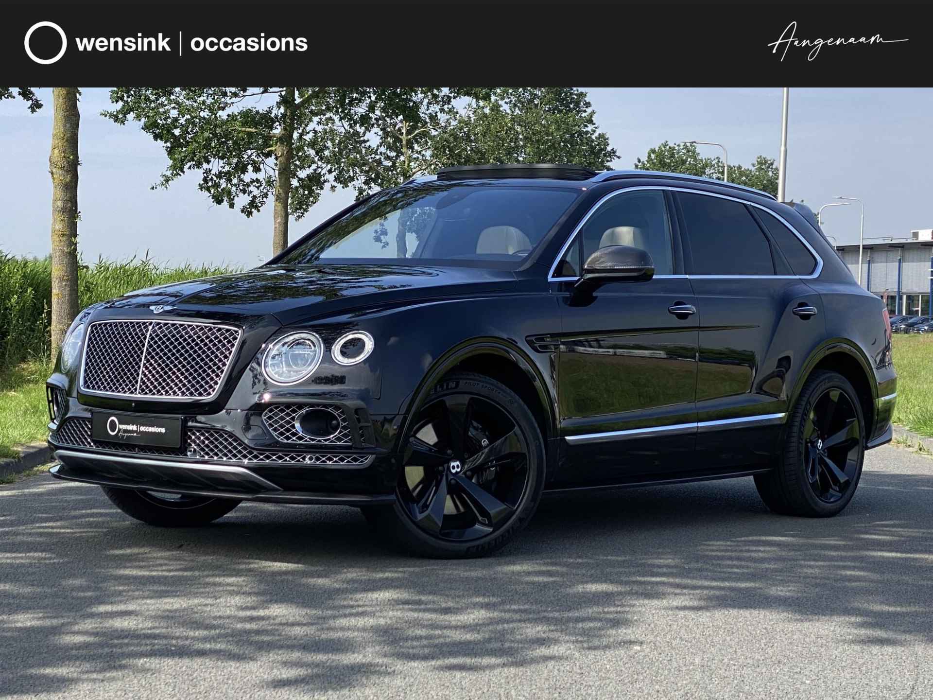 Bentley Bentayga 6.0 W12 | Nachtzicht | Adaptieve CruiseControl | 360 Camera | Panoramadak | 22” Lichtmetaal | Stuurwiel verwarmd | Elektrische zetels + Geheugen | NAIM Sound | Elektrische Trekhaak | Niveau Regeling | Carbon Pakket | NL Auto | - 1/97